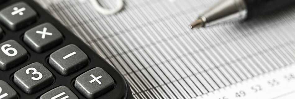 Calculator and Pen on Table